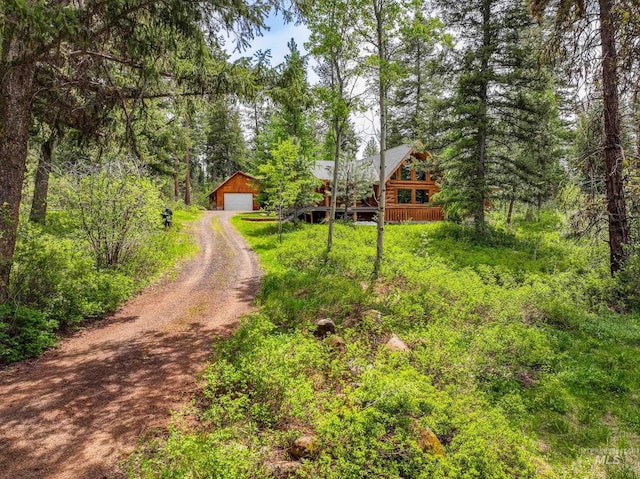 881 Sheila, Mccall, ID 83638 - view of dirt / gravel driveway featuring a view of trees