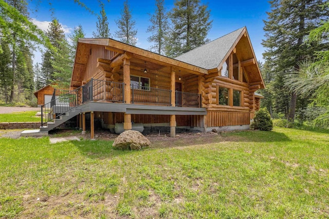 881 Sheila, Mccall, ID 83638 - back of property with log siding, a lawn, stairs, and roof with shingles