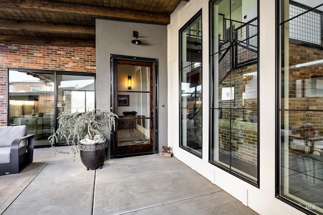 view of exterior entry featuring brick siding