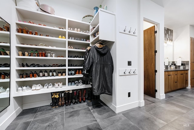 walk in closet featuring tile patterned flooring and a sink