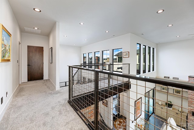 corridor with recessed lighting, an upstairs landing, baseboards, and carpet floors