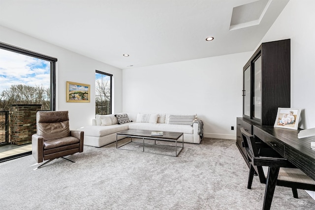 living room featuring recessed lighting, baseboards, and carpet