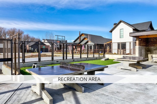 exterior space featuring a residential view, community basketball court, and fence