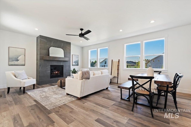 2394 E Monhegan Dr, Eagle, ID 83616 - living area featuring ceiling fan, wood finished floors, a tile fireplace, recessed lighting, and baseboards