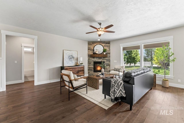 12462 S Sunrise Mist Loop, Nampa, ID 83686 - living area featuring ceiling fan, hardwood / wood-style flooring, a textured ceiling, and a stone fireplace