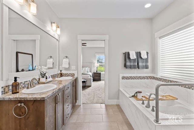 12462 S Sunrise Mist Loop, Nampa, ID 83686 - ensuite bathroom featuring double vanity, a garden tub, and tile patterned floors
