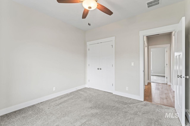 12462 S Sunrise Mist Loop, Nampa, ID 83686 - unfurnished bedroom with carpet, a closet, and ceiling fan