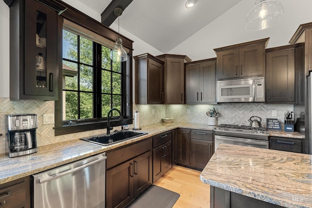 1520 Roosevelt Ave, Mccall, ID 83638 - kitchen featuring appliances with stainless steel finishes, lofted ceiling, a sink, dark brown cabinetry, and tasteful backsplash