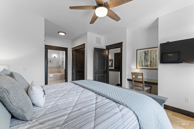 1520 Roosevelt Ave, Mccall, ID 83638 - bedroom featuring wood finished floors, ensuite bathroom, ceiling fan, and baseboards