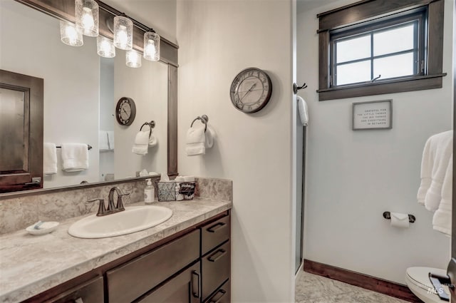 1520 Roosevelt Ave, Mccall, ID 83638 - bathroom featuring vanity, toilet, baseboards, and a stall shower