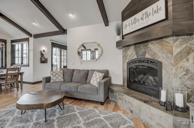 1520 Roosevelt Ave, Mccall, ID 83638 - living area with beam ceiling, wood finished floors, a tile fireplace, and baseboards