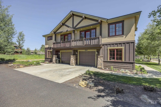 1520 Roosevelt Ave, Mccall, ID 83638 - view of front facade with driveway, an attached garage, stucco siding, and a balcony