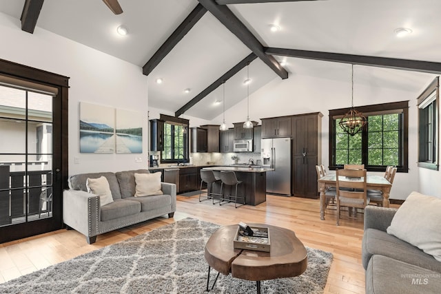 1520 Roosevelt Ave, Mccall, ID 83638 - living room with a chandelier, beamed ceiling, light wood finished floors, and high vaulted ceiling