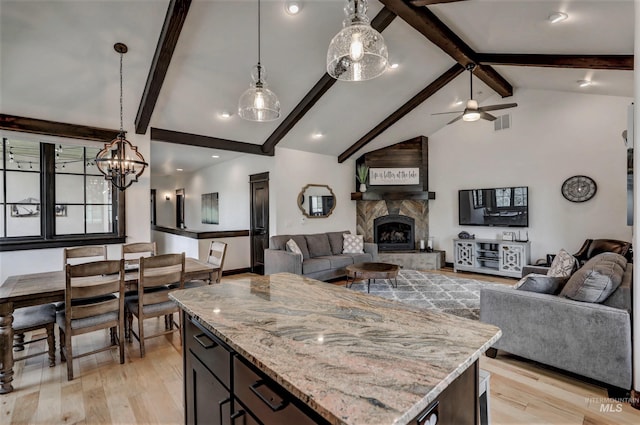 1520 Roosevelt Ave, Mccall, ID 83638 - kitchen featuring open floor plan, light wood-type flooring, a fireplace, and ceiling fan