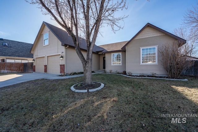 view of front of property with a garage, a front yard, fence, and driveway