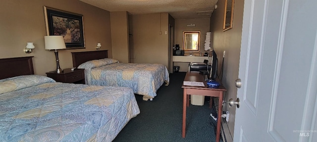 bedroom with a textured ceiling and carpet flooring