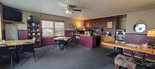 carpeted home office with a textured ceiling and ceiling fan