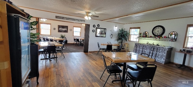 dining space featuring a textured ceiling, a healthy amount of sunlight, dark hardwood / wood-style floors, and ceiling fan