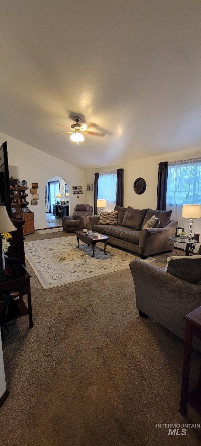 carpeted living room with ceiling fan