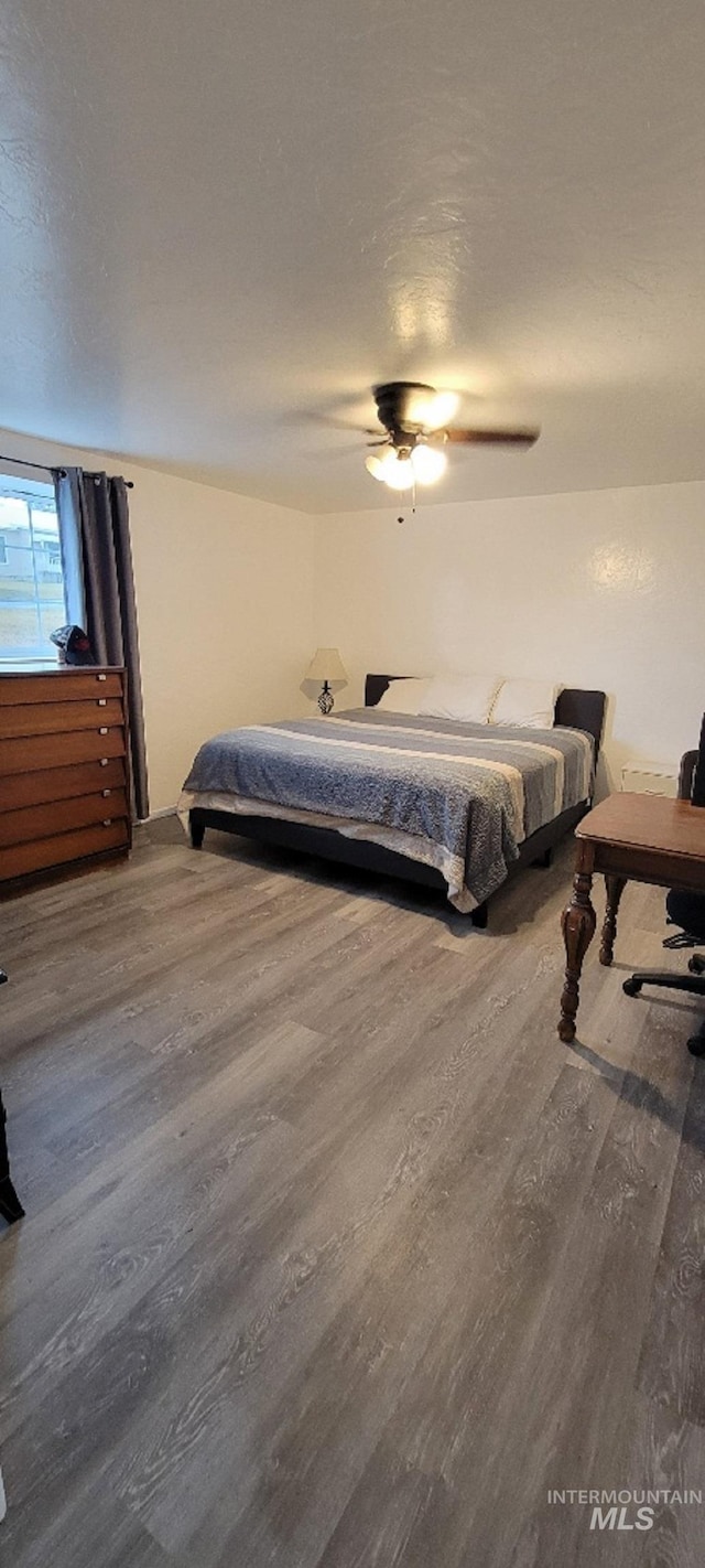 bedroom featuring hardwood / wood-style floors and ceiling fan