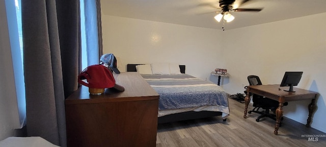 bedroom with wood-type flooring and ceiling fan