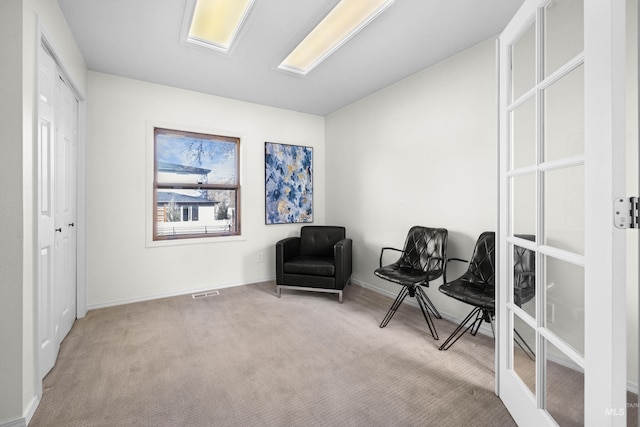 sitting room with visible vents, carpet floors, baseboards, and french doors