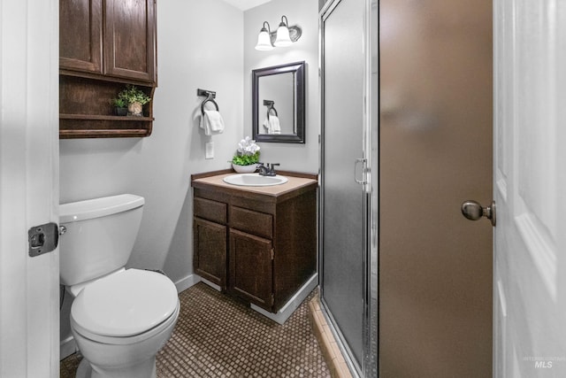 full bathroom featuring vanity, toilet, baseboards, and a stall shower