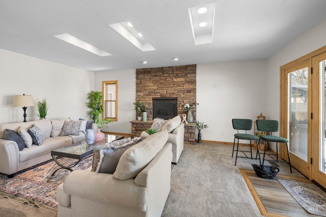 living room with a wealth of natural light, baseboards, light colored carpet, and a skylight