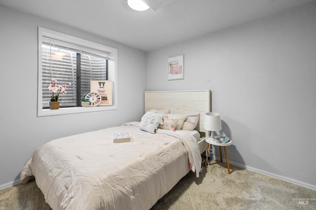 bedroom with carpet flooring and baseboards