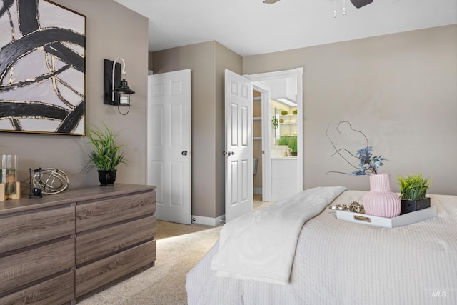 bedroom featuring light colored carpet, a ceiling fan, and baseboards