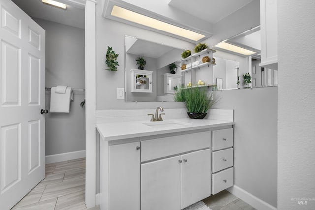 bathroom featuring baseboards and vanity