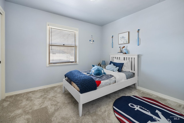 bedroom with carpet and baseboards