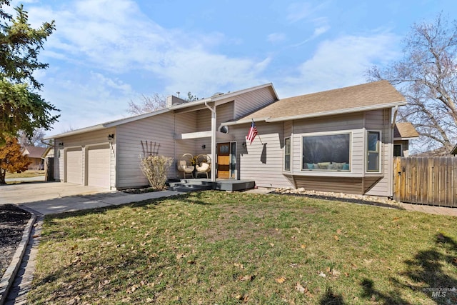 view of front of property with an attached garage, a chimney, a front yard, and fence