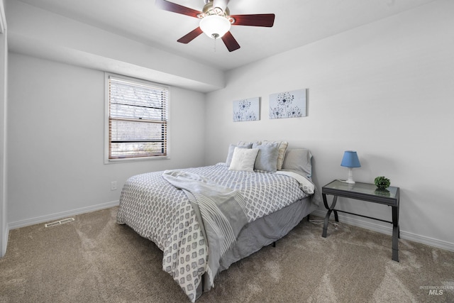 bedroom featuring visible vents, baseboards, carpet floors, and ceiling fan