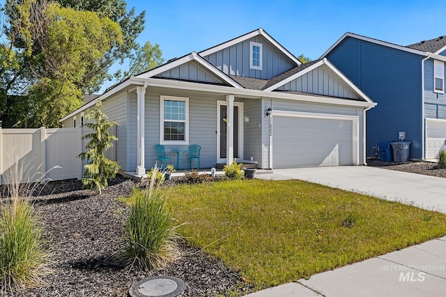 11002 W Hidden Point St, Star, ID 83669 - view of front of house with board and batten siding, a porch, an attached garage, concrete driveway, and roof with shingles