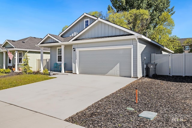 11002 W Hidden Point St, Star, ID 83669 - view of front of home with board and batten siding, an attached garage, concrete driveway, and covered porch