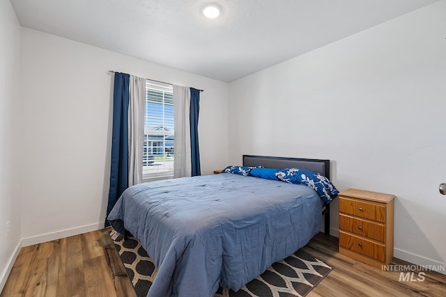 11002 W Hidden Point St, Star, ID 83669 - bedroom featuring wood finished floors and baseboards