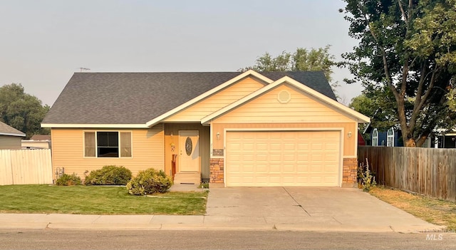 view of front of home with a garage and a front lawn