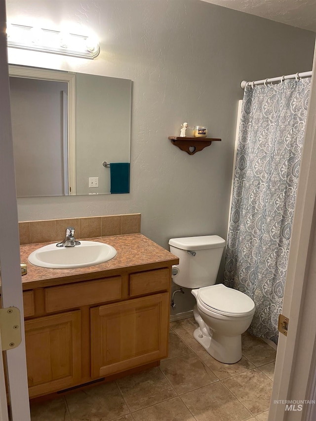 bathroom featuring vanity, toilet, and tile patterned floors