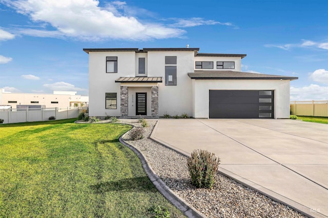 view of front of home featuring a front lawn and a garage