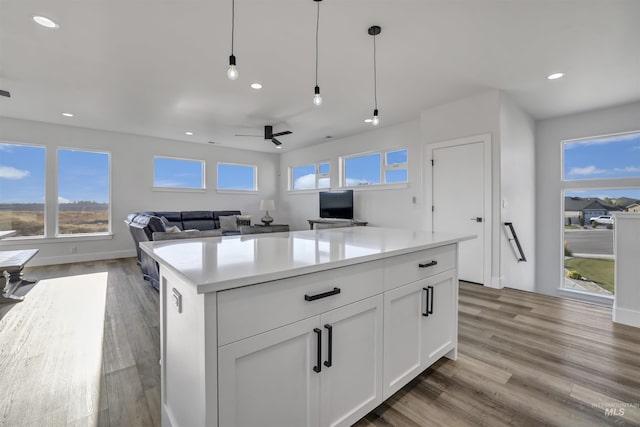 kitchen featuring recessed lighting, white cabinets, light countertops, and plenty of natural light
