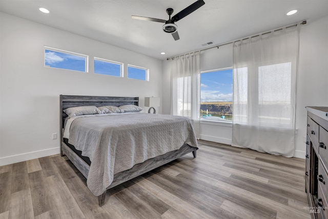 bedroom with visible vents, a ceiling fan, light wood-style floors, and recessed lighting