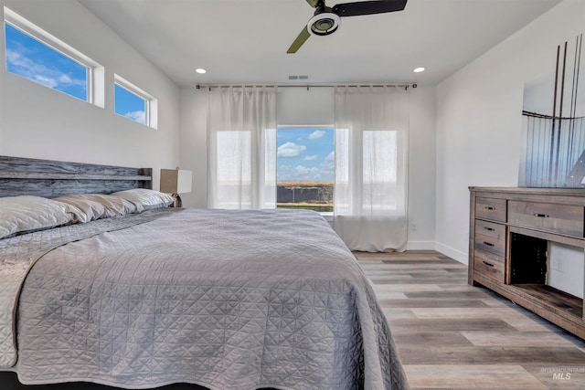 bedroom featuring light hardwood / wood-style flooring and ceiling fan