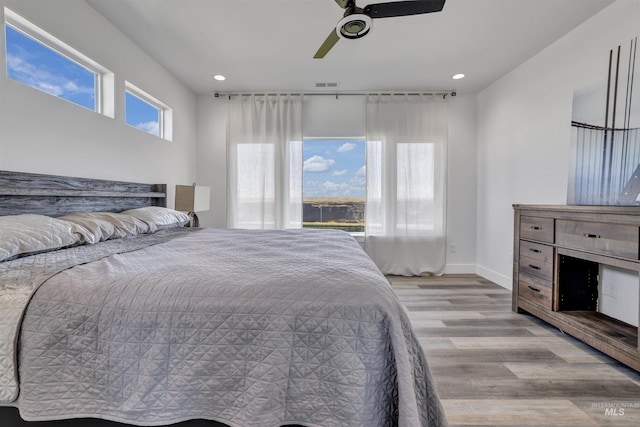bedroom featuring light wood-style flooring, visible vents, ceiling fan, baseboards, and recessed lighting