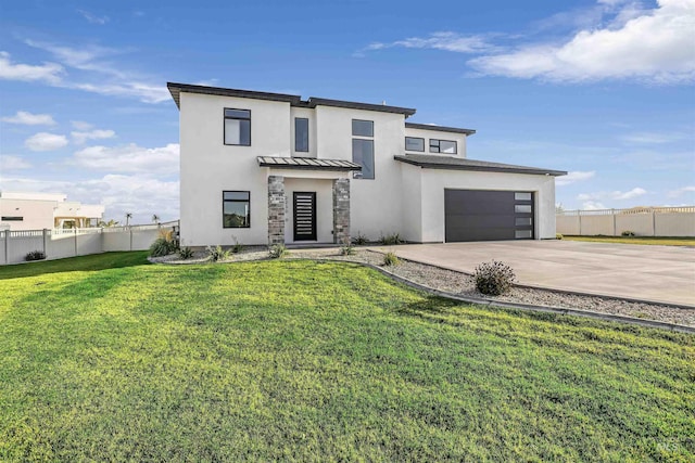 modern farmhouse featuring fence, concrete driveway, a standing seam roof, a front yard, and stucco siding