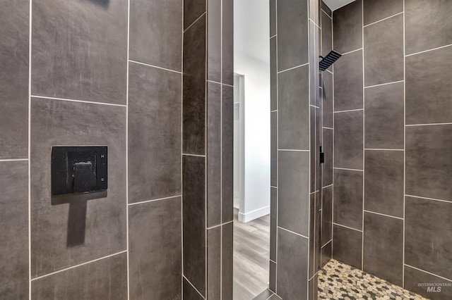 interior details featuring tiled shower