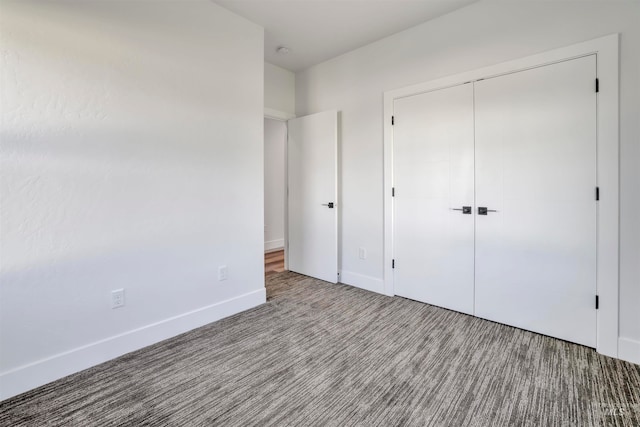 unfurnished bedroom featuring a closet and carpet flooring