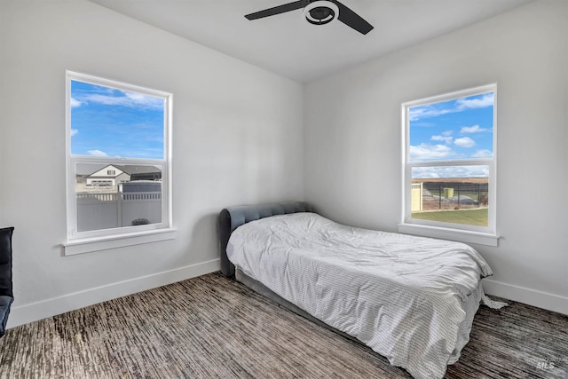 bedroom with carpet flooring, multiple windows, and ceiling fan