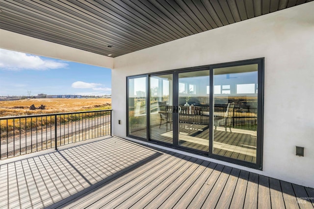 wooden terrace featuring a rural view