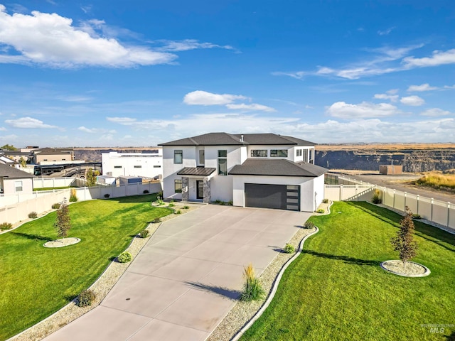 view of front facade featuring a front lawn and a garage